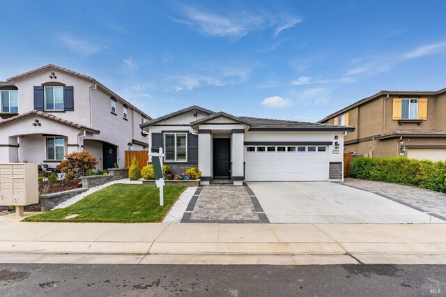 view of front of house featuring an attached garage, stucco siding, driveway, and a front yard