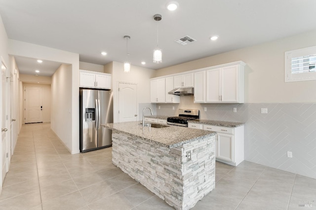 kitchen with light tile patterned floors, a sink, visible vents, under cabinet range hood, and appliances with stainless steel finishes