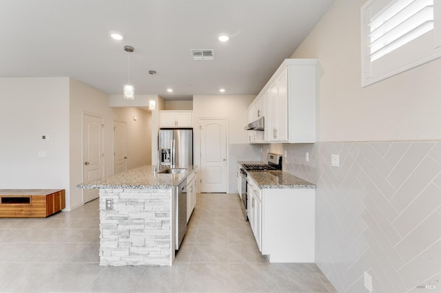 kitchen with white cabinetry, light stone counters, visible vents, and appliances with stainless steel finishes