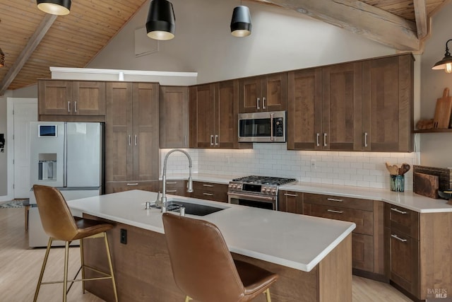6200 Burnside Rd, Sebastopol, CA 95472 - kitchen with a sink, appliances with stainless steel finishes, decorative backsplash, a breakfast bar area, and wooden ceiling
