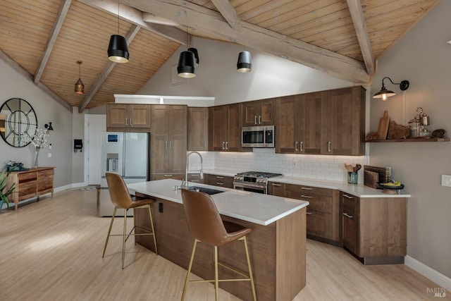 6200 Burnside Rd, Sebastopol, CA 95472 - kitchen with appliances with stainless steel finishes, a sink, light wood-style flooring, wooden ceiling, and a breakfast bar area