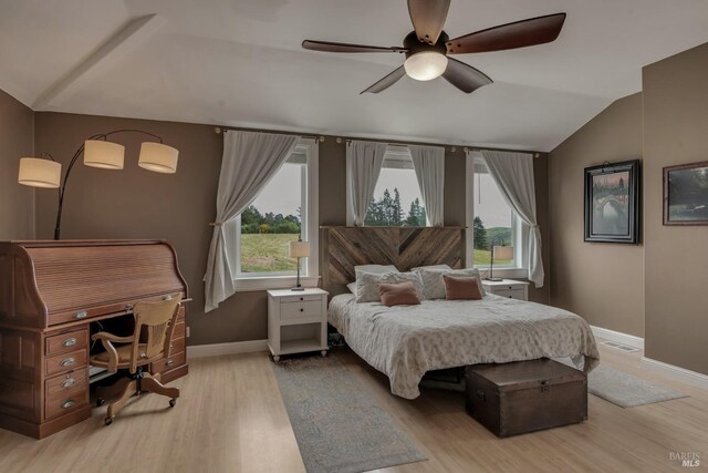 6200 Burnside Rd, Sebastopol, CA 95472 - bedroom featuring multiple windows, vaulted ceiling, light wood-type flooring, baseboards, and a ceiling fan