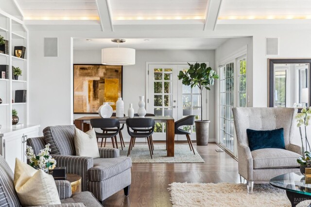 sunroom featuring french doors and beam ceiling