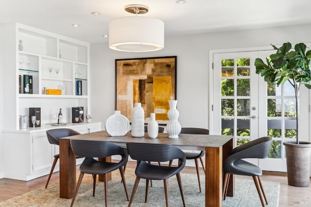 dining area with french doors and wood finished floors
