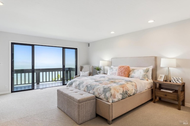 bedroom featuring access to outside, recessed lighting, carpet, and a water view