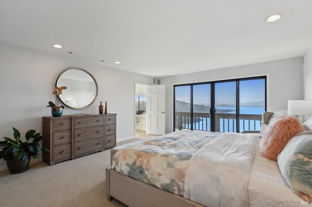 bedroom with a water view, access to outside, light carpet, and recessed lighting