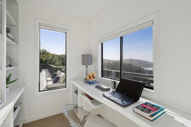 carpeted home office featuring baseboards and a healthy amount of sunlight