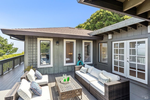 wooden terrace with an outdoor living space and french doors