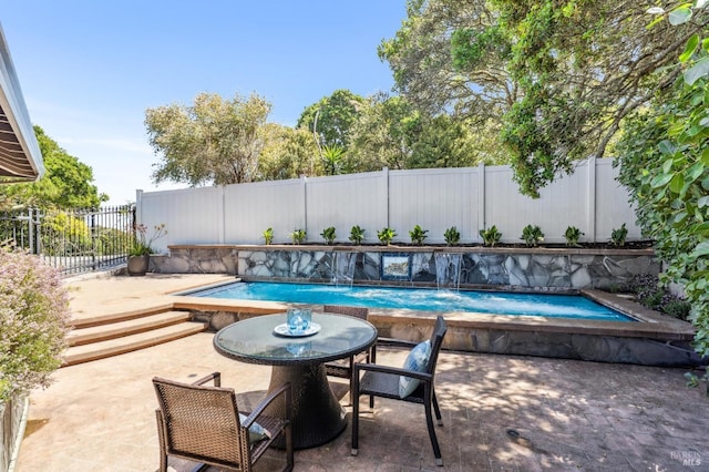 view of pool featuring a patio, a fenced in pool, and a fenced backyard
