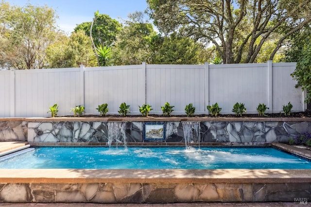 view of pool featuring fence