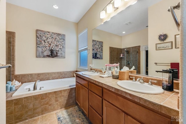 bathroom with a sink, double vanity, a shower stall, and a bath