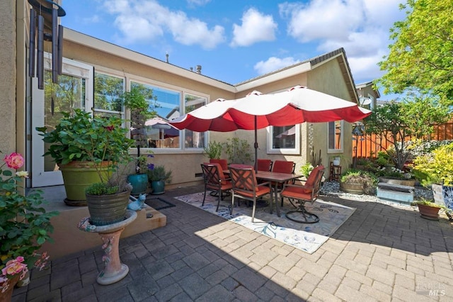 view of patio with fence and outdoor dining area
