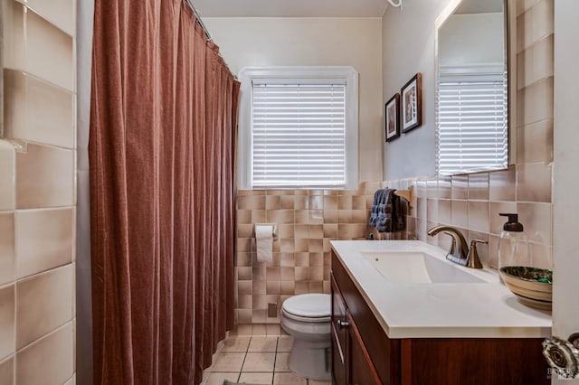 bathroom with tile walls, vanity, tile patterned floors, toilet, and a shower with shower curtain
