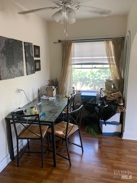 dining room featuring baseboards, ceiling fan, and wood finished floors
