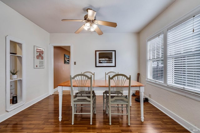 dining room with baseboards, a ceiling fan, and dark wood-style flooring