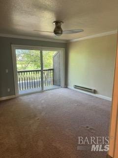 empty room with a ceiling fan, baseboard heating, baseboards, carpet floors, and ornamental molding