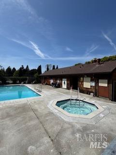 pool featuring a patio and a community hot tub