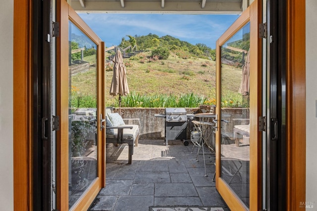 doorway to outside with stone tile floors