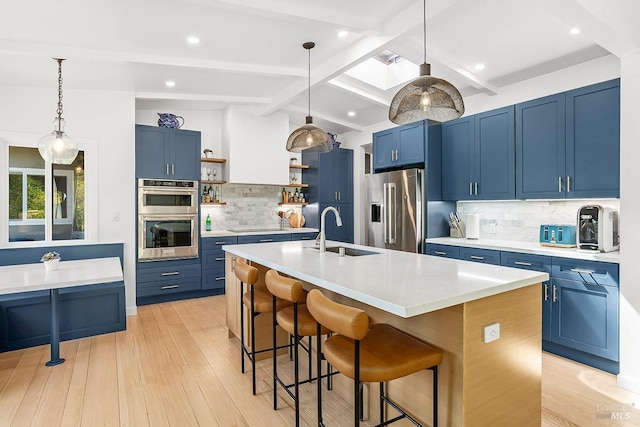 5 Oak Springs Dr, San Anselmo, CA 94960 - kitchen with blue cabinetry, open shelves, a sink, a breakfast bar, and stainless steel appliances