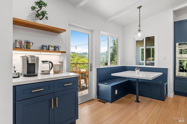 5 Oak Springs Dr, San Anselmo, CA 94960 - interior space with stainless steel double oven, beamed ceiling, hanging light fixtures, and light wood-type flooring