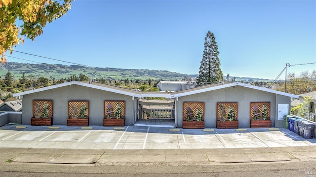 view of front of house with a mountain view and stucco siding