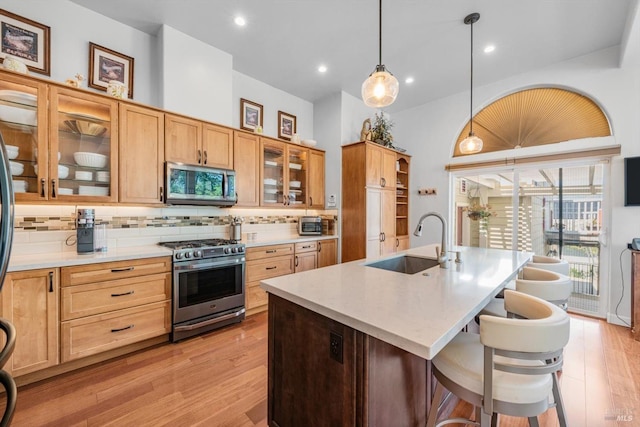 1300 Steele Canyon Rd, Napa, CA 94558 - kitchen with backsplash, a sink, light countertops, stainless steel appliances, and light wood-style flooring
