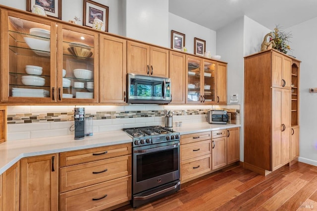 1300 Steele Canyon Rd, Napa, CA 94558 - kitchen with light countertops, appliances with stainless steel finishes, backsplash, and dark wood-style floors