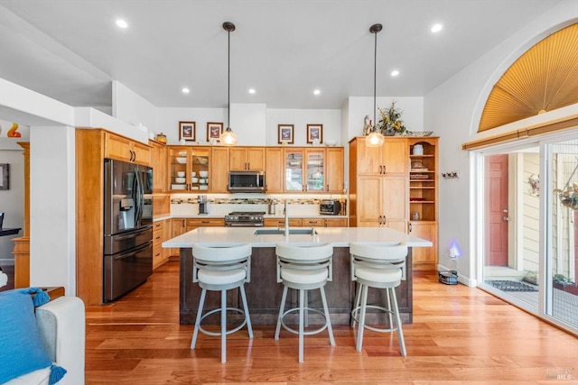 1300 Steele Canyon Rd, Napa, CA 94558 - kitchen featuring a kitchen breakfast bar, tasteful backsplash, a sink, light wood-style flooring, and appliances with stainless steel finishes