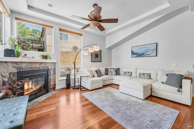 1300 Steele Canyon Rd, Napa, CA 94558 - living area featuring a fireplace with flush hearth, a raised ceiling, ceiling fan, and wood finished floors