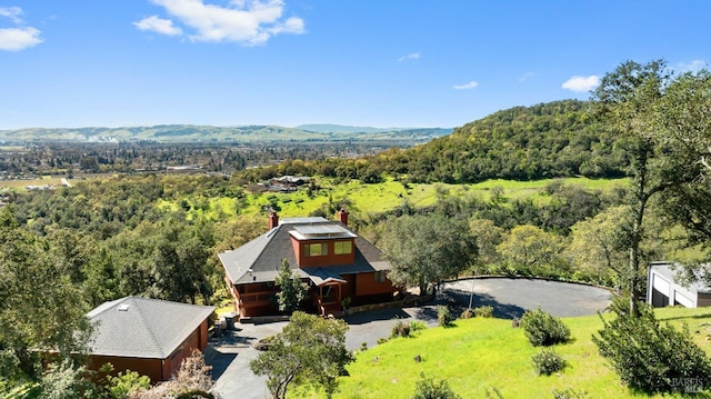 birds eye view of property with a view of trees