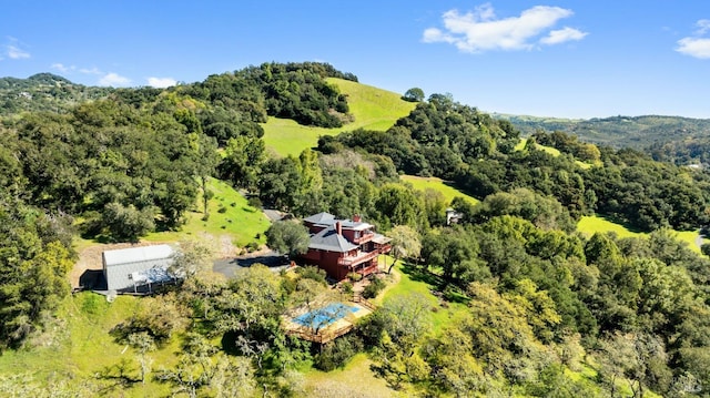 birds eye view of property featuring a view of trees