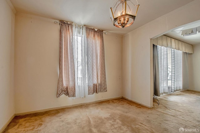 empty room with carpet floors, baseboards, a chandelier, and plenty of natural light