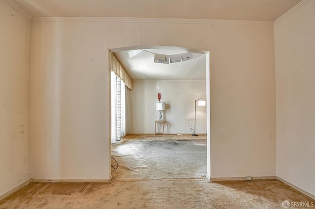 hallway featuring baseboards, carpet flooring, and crown molding