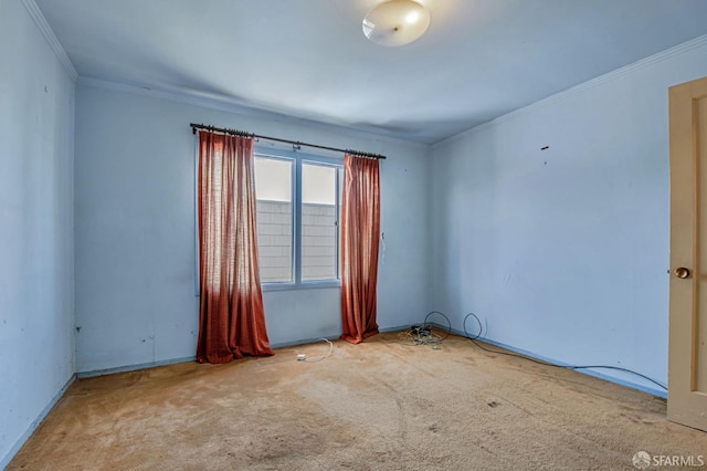 spare room featuring crown molding and carpet flooring