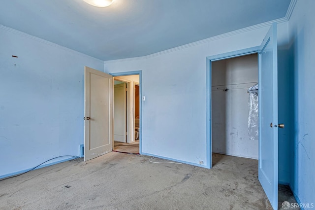 unfurnished bedroom featuring carpet floors, ornamental molding, and a closet