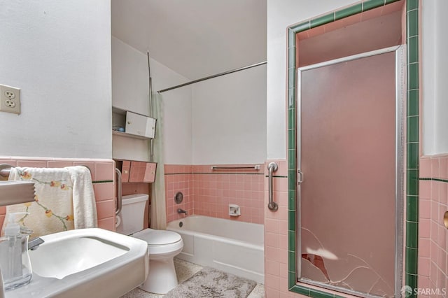 full bathroom with toilet, a shower with door, a tub, and a wainscoted wall