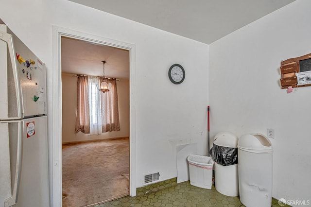 interior space featuring visible vents and an inviting chandelier