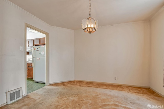 spare room with crown molding, light colored carpet, a chandelier, and visible vents