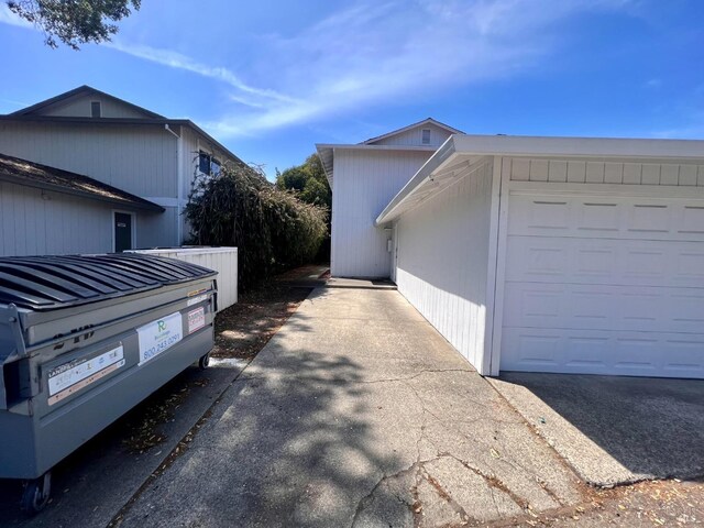 view of side of property featuring an attached garage