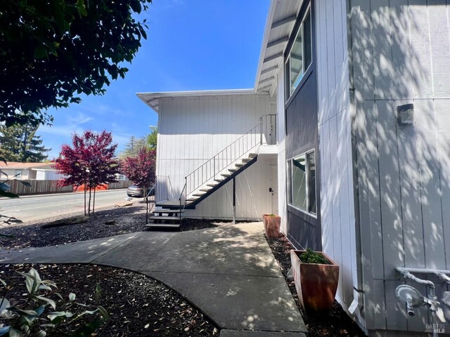 exterior space featuring stairs and a patio