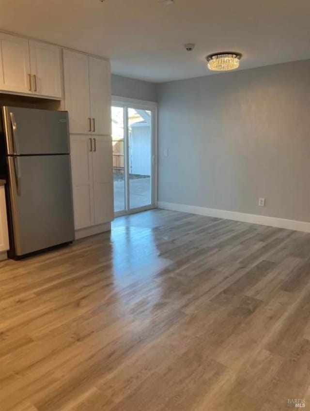 interior space featuring light wood-style floors and baseboards