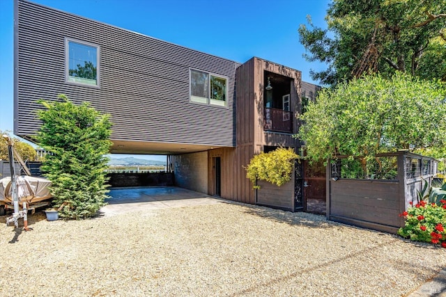 contemporary home featuring a carport and driveway