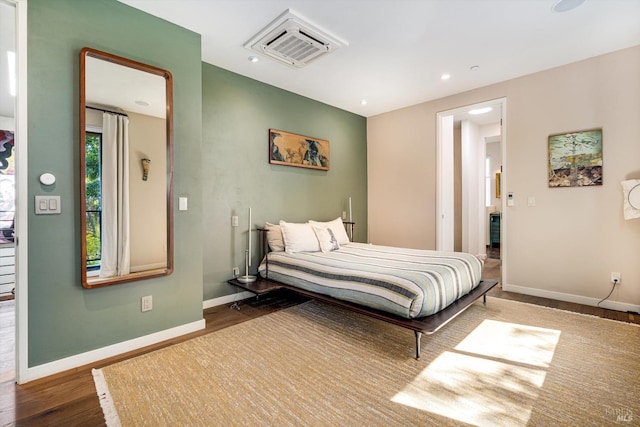 bedroom featuring recessed lighting, baseboards, visible vents, and wood finished floors