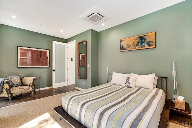 bedroom featuring baseboards, recessed lighting, wood finished floors, and visible vents