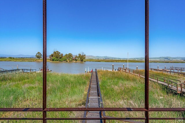 water view with fence and a mountain view