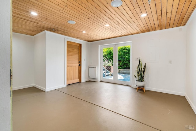 empty room with recessed lighting, baseboards, concrete flooring, and wooden ceiling