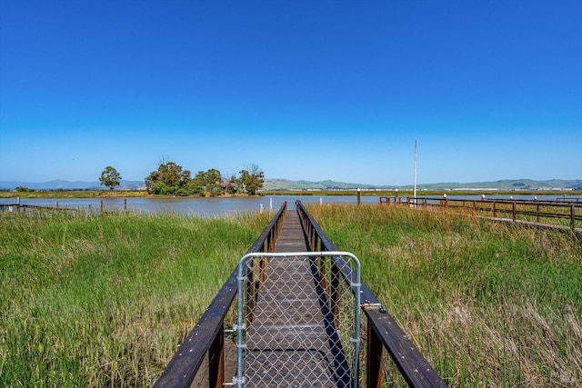 exterior space featuring fence and a water and mountain view
