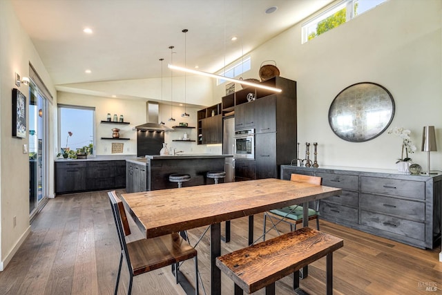 dining space with recessed lighting, baseboards, high vaulted ceiling, and hardwood / wood-style flooring
