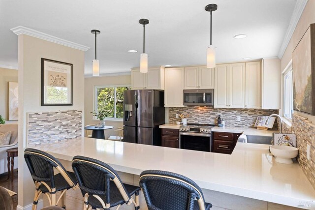 kitchen with a sink, crown molding, backsplash, and stainless steel appliances