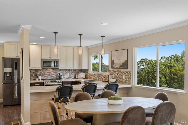 dining room featuring crown molding, dark wood-style flooring, baseboards, and recessed lighting